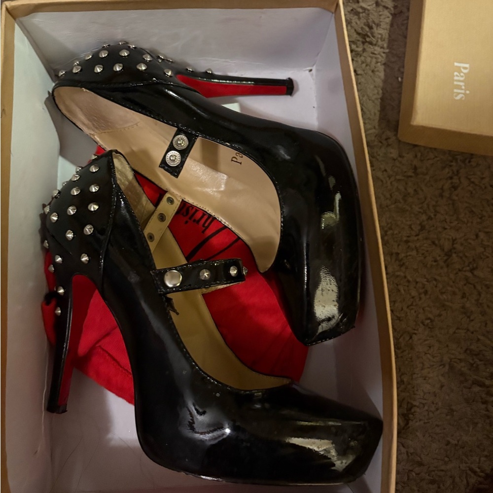 AUTHENTIC Christian Louboutin Mad Mary studded pumps in black patent leather.